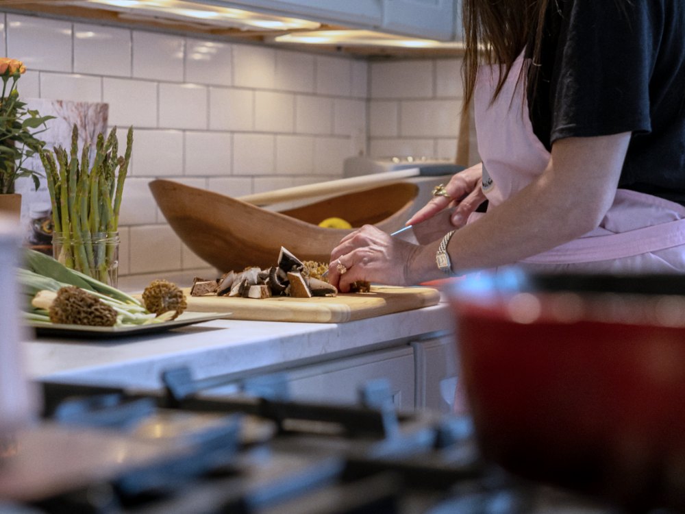Private chef preparing a meal in a rental kitchen