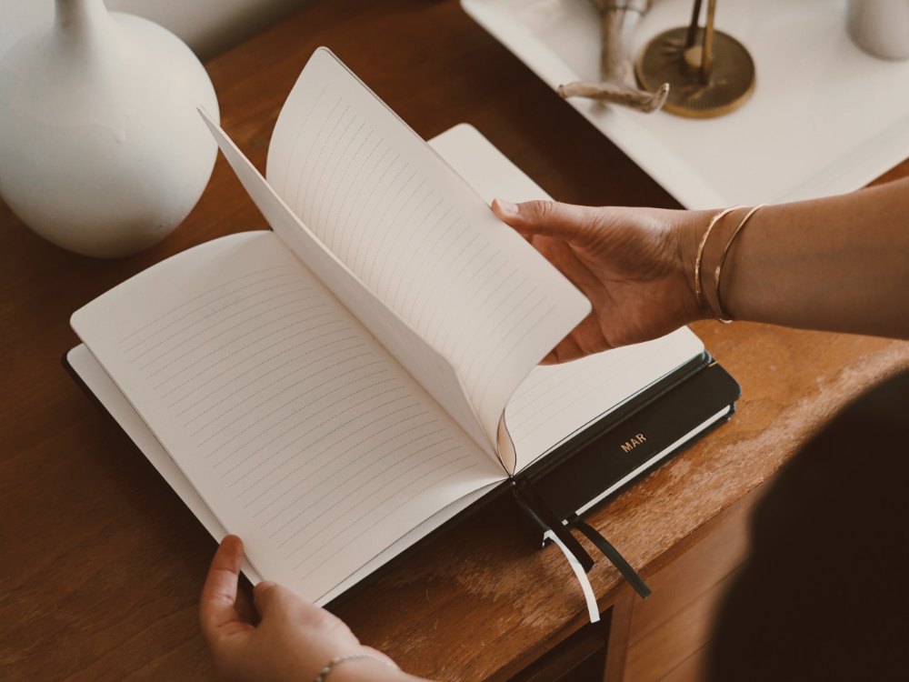 Weekly planner and pen on a desk, personal concierge scheduling